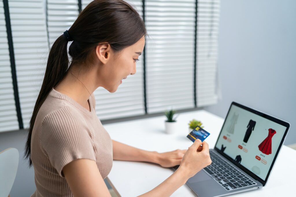 Asian young woman use laptop computer for shopping product sell online.